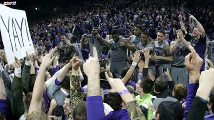 Feb 23, 2015; Manhattan, KS, USA; Kansas State Wildcats players celebrate on the scorers table following a 70-63 win against the Kansas Jayhawks at Fred Bramlage Coliseum. Mandatory Credit: Scott Sewell-USA TODAY Sports