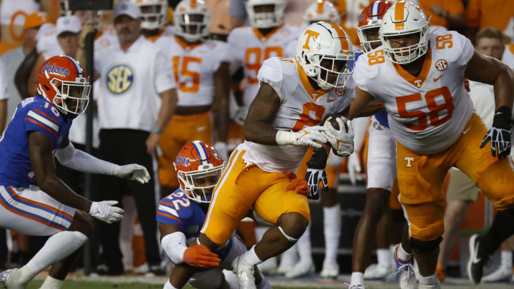 Sep 25, 2021; Gainesville, Florida, USA; Tennessee Volunteers running back Tiyon Evans (8) runs past Florida Gators safety Rashad Torrence II (22) for a touchdown against the Florida Gators during the first quarter at Ben Hill Griffin Stadium. Mandatory Credit: Kim Klement-USA TODAY Sports