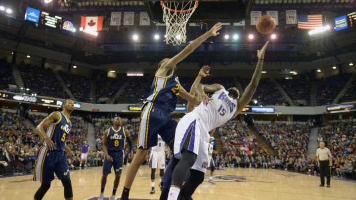 Mar 13, 2016; Sacramento, CA, USA; Sacramento Kings center DeMarcus Cousins (15) is defended by Utah Jazz center Rudy Gobert (27) during an NBA game at Sleep Train Arena. The Jazz defeated the Kings 108-99. Mandatory Credit: Kirby Lee-USA TODAY Sports