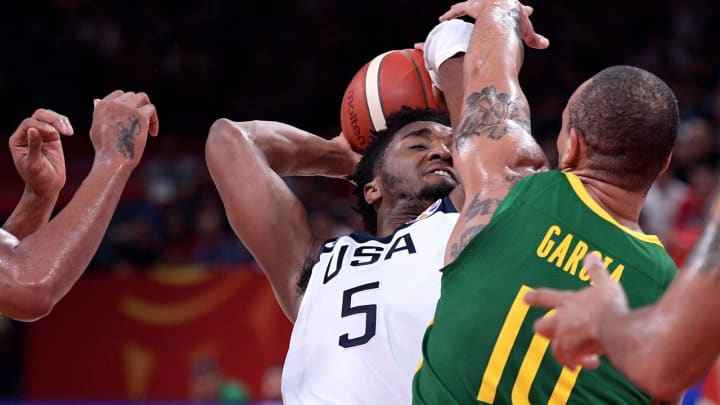 TOPSHOT – Brazil’s Alex Garcia (R) fights for the ball with Donovan Mitchell of the US during the Basketball World Cup Group K second round game between US and Brazil in Shenzhen on September 9, 2019. (Photo by Nicolas ASFOURI / AFP) (Photo credit should read NICOLAS ASFOURI/AFP/Getty Images)
