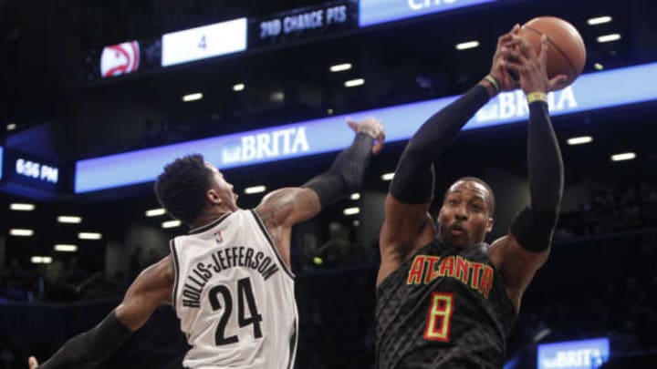 Apr 2, 2017; Brooklyn, NY, USA; Atlanta Hawks center Dwight Howard (8) rebounds against Brooklyn Nets guard Rondae Hollis-Jefferson (24) in the second quarter at Barclays Center. Mandatory Credit: Nicole Sweet-USA TODAY Sports