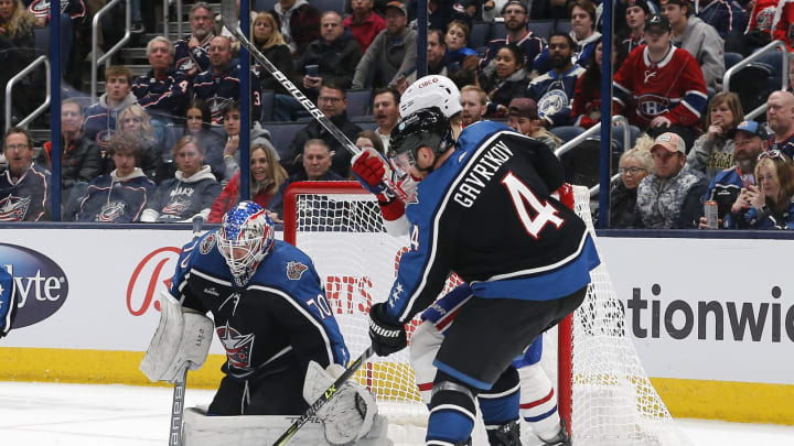 Nov 23, 2022; Columbus, Ohio, USA; Columbus Blue Jackets defenseman Vladislav Gavrikov (4) clears the puck from a Columbus Blue Jackets goalie Joonas Korpisalo (70) save against the Montreal Canadiens during the second period at Nationwide Arena. Mandatory Credit: Russell LaBounty-USA TODAY Sports