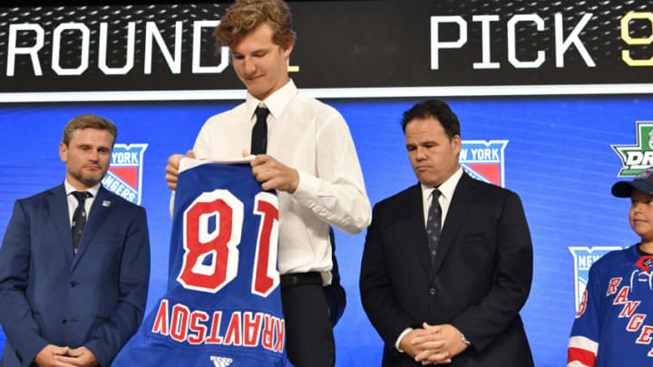 Jun 22, 2018; Dallas, TX, USA; Vitali Kravtsov puts on a team jersey after being selected as the number nine overall pick to the New York Rangers in the first round of the 2018 NHL Draft at American Airlines Center. Mandatory Credit: Jerome Miron-USA TODAY Sports