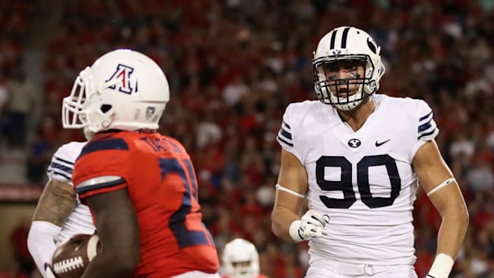 TUCSON, AZ - SEPTEMBER 01: Defensive lineman Corbin Kaufusi #90 of the Brigham Young Cougars reacts to a defensive stop on running back J.J. Taylor #21 of the Arizona Wildcats during the college football game at Arizona Stadium on September 1, 2018 in Tucson, Arizona. The Cougars defeated the Wildcats 28-23. (Photo by Christian Petersen/Getty Images)