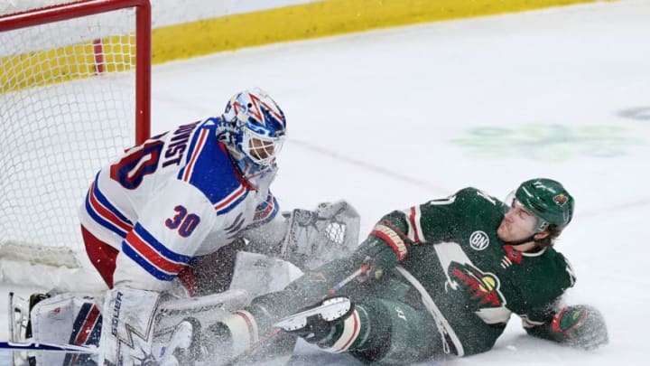ST PAUL, MN - MARCH 16: Henrik Lundqvist #30 of the New York Rangers makes a save as Marcus Foligno #17 of the Minnesota Wild slides into him during the third period of the game on March 16, 2019 at Xcel Energy Center in St Paul, Minnesota. The Wild defeated the Rangers 5-2. (Photo by Hannah Foslien/Getty Images)