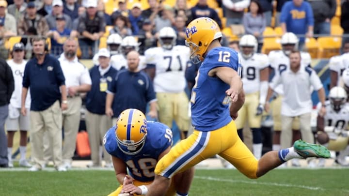 Oct 8, 2016; Pittsburgh, PA, USA; Pittsburgh Panthers place kicker Chris Blewitt (12) kicks a game winning thirty-one yard field goal from the hold of Pittsburgh Panthers punter Ryan Winslow (18) against the Georgia Tech Yellow Jackets during the fourth quarter at Heinz Field. Pittsburgh won 37-34. Mandatory Credit: Charles LeClaire-USA TODAY Sports