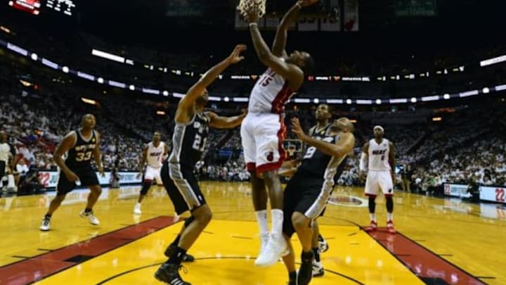 Jun 12, 2014; Miami, FL, USA; Miami Heat guard Mario Chalmers (15) shoots against San Antonio Spurs forward Tim Duncan (21) during the third quarter of game four of the 2014 NBA Finals at American Airlines Arena. Mandatory Credit: Bob Donnan-USA TODAY Sports