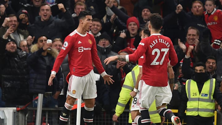 Manchester United's Portuguese striker Cristiano Ronaldo (L) celebrates after scoring their second goal, his 800th for club and country in his career during the English Premier League football match between Manchester United and Arsenal at Old Trafford in Manchester, north west England, on December 2, 2021. - RESTRICTED TO EDITORIAL USE. No use with unauthorized audio, video, data, fixture lists, club/league logos or 'live' services. Online in-match use limited to 120 images. An additional 40 images may be used in extra time. No video emulation. Social media in-match use limited to 120 images. An additional 40 images may be used in extra time. No use in betting publications, games or single club/league/player publications. (Photo by Oli SCARFF / AFP) / RESTRICTED TO EDITORIAL USE. No use with unauthorized audio, video, data, fixture lists, club/league logos or 'live' services. Online in-match use limited to 120 images. An additional 40 images may be used in extra time. No video emulation. Social media in-match use limited to 120 images. An additional 40 images may be used in extra time. No use in betting publications, games or single club/league/player publications. / RESTRICTED TO EDITORIAL USE. No use with unauthorized audio, video, data, fixture lists, club/league logos or 'live' services. Online in-match use limited to 120 images. An additional 40 images may be used in extra time. No video emulation. Social media in-match use limited to 120 images. An additional 40 images may be used in extra time. No use in betting publications, games or single club/league/player publications. (Photo by OLI SCARFF/AFP via Getty Images)