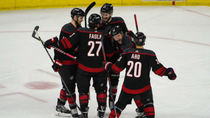 RALEIGH, NC - MAY 01: Carolina Hurricanes right wing Justin Williams (14) celebrates with teammates after scoring the game winning goal during a game between the Carolina Hurricanes and the New York Islanders on May 1, 2019 at the PNC Arena in Raleigh, NC. (Photo by Greg Thompson/Icon Sportswire via Getty Images)