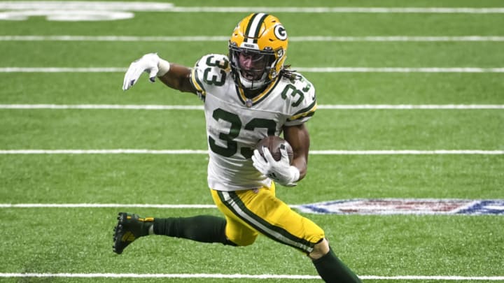 DETROIT, MICHIGAN - DECEMBER 13: Aaron Jones #33 of the Green Bay Packers runs the ball against the Detroit Lions during the second half at Ford Field on December 13, 2020 in Detroit, Michigan. (Photo by Nic Antaya/Getty Images)