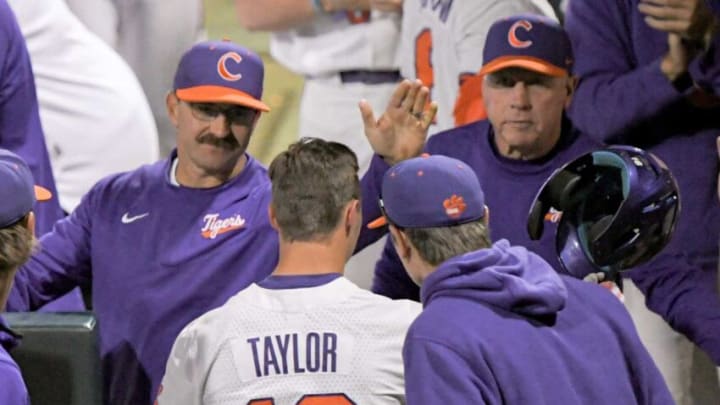 Clemson Head Coach Erik Bakich, left, and Clemson director of program development Jack Leggett , right, congratulate Clemson sophomore Will Taylor (16) scoring during the bottom of the eighth inning at Doug Kingsmore Stadium in Clemson Thursday, March 30, 2023.Clemson Baseball Vs Wake Forest March 30 2023