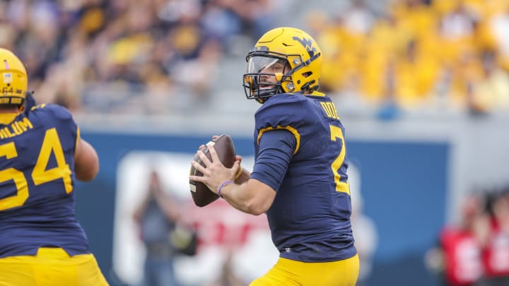 Oct 2, 2021; Morgantown, West Virginia, USA; West Virginia Mountaineers quarterback Jarret Doege (2) drops back for a pass during the first quarter against the Texas Tech Red Raiders at Mountaineer Field at Milan Puskar Stadium. Mandatory Credit: Ben Queen-USA TODAY Sports