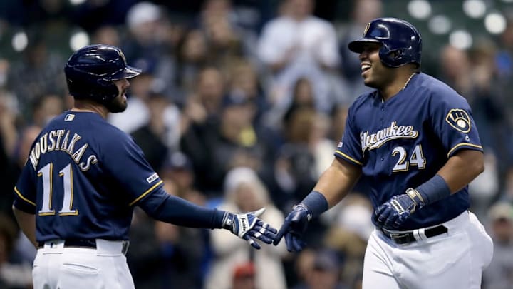 MILWAUKEE, WISCONSIN - APRIL 29: Mike Moustakas #11 and Jesus Aguilar #24 of the Milwaukee Brewers celebrate after Aguilar hit a home run in the first inning against the Colorado Rockies at Miller Park on April 29, 2019 in Milwaukee, Wisconsin. (Photo by Dylan Buell/Getty Images)