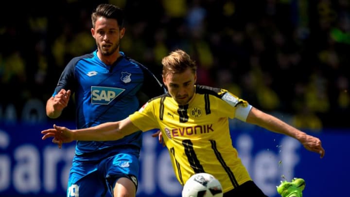 Dortmund's defender Marcel Schmelzer (R) and Hoffenheim's forward Mark Uth vie for the ball during the German first division Bundesliga football match between Borussia Dortmund and TSG 1899 Hoffenheim on May 6, 2017 in Dortmund, western Germany. / AFP PHOTO / SASCHA SCHUERMANN / RESTRICTIONS: DURING MATCH TIME: DFL RULES TO LIMIT THE ONLINE USAGE TO 15 PICTURES PER MATCH AND FORBID IMAGE SEQUENCES TO SIMULATE VIDEO. == RESTRICTED TO EDITORIAL USE == FOR FURTHER QUERIES PLEASE CONTACT DFL DIRECTLY AT 49 69 650050 (Photo credit should read SASCHA SCHUERMANN/AFP/Getty Images)