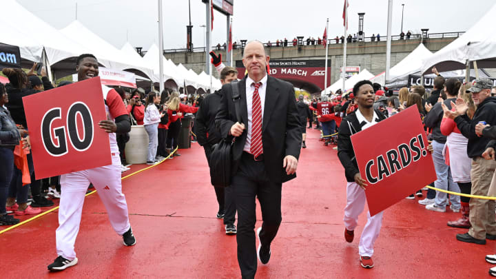 Oct 28, 2023; Louisville, Kentucky, USA; Louisville Cardinals head coach Jeff Brohm leads the team to the stadium during the Card March before facing off against the Duke Blue Devils at L&N Federal Credit Union Stadium. Mandatory Credit: Jamie Rhodes-USA TODAY Sports