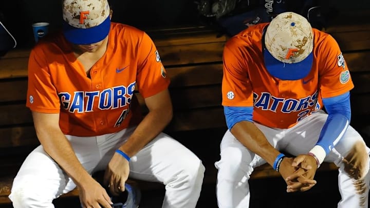 Jun 20, 2015; Omaha, NE, USA; Florida Gators outfielder Buddy Reed (23) and infielder John Sternagel (44) sit iin the dugout after the loss against the Virginia Cavaliers in the 2015 College World Series at TD Ameritrade Park. Mandatory Credit: Steven Branscombe-USA TODAY Sports