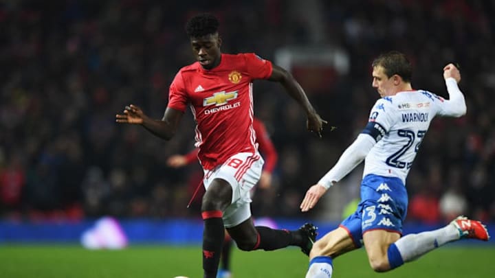 MANCHESTER, ENGLAND - JANUARY 29: Axel Tuanzebe of Manchester United is tackled by Stephen Warnock of Wigan Athletic during the Emirates FA Cup Fourth round match between Manchester United and Wigan Athletic at Old Trafford on January 29, 2017 in Manchester, England. (Photo by Gareth Copley/Getty Images)