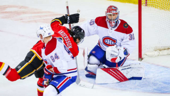 Apr 24, 2021; Calgary, Alberta, CAN; Montreal Canadiens goaltender Cayden Primeau (30) makes a save against Calgary Flames defenseman Rasmus Andersson (4) during the third period at Scotiabank Saddledome. Mandatory Credit: Sergei Belski-USA TODAY Sports