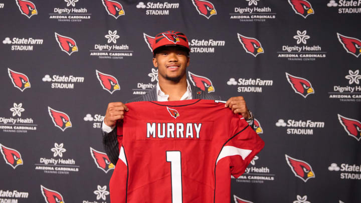 Apr 26, 2019; Tempe, AZ, USA; Arizona Cardinals quarterback Kyler Murray poses for a photo holding his jersey at the Cardinals Training Facility after being drafted with the first overall pick in the 2019 NFL Draft. Mandatory Credit: Mark J. Rebilas-USA TODAY Sports