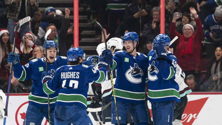 VANCOUVER, CANADA – DECEMBER 22: Elias Pettersson #40 of the Vancouver Canucks celebrates with teammates Andrei Kuzmenko #96, Quinn Hughes #43 and Bo Horvat #53 after scoring a goal to tie the game against the Seattle Kraken during the third period in NHL action on December, 22, 2022 at Rogers Arena in Vancouver, British Columbia, Canada. (Photo by Rich Lam/Getty Images)