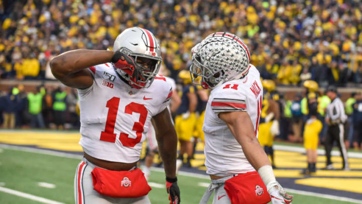 ANN ARBOR, MICHIGAN - NOVEMBER 30: Rashod Berry #13 and Austin Mack #11 of the Ohio State Buckeyes celebrate a touchdown during the second half of a college football game against the Michigan Wolverines at Michigan Stadium on November 30, 2019 in Ann Arbor, Michigan. The Ohio State Buckeyes won the game 56-27 over the Michigan Wolverines. (Photo by Aaron J. Thornton/Getty Images)