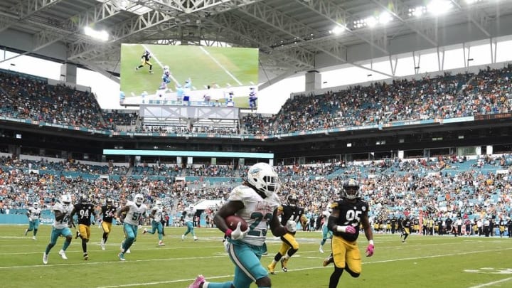 Oct 16, 2016; Miami Gardens, FL, USA; Miami Dolphins running back Jay Ajayi (23) runs past Pittsburgh Steelers outside linebacker Jarvis Jones (95) for a touchdown during the second half at Hard Rock Stadium. The Dolphins won 30-15. Mandatory Credit: Steve Mitchell-USA TODAY Sports