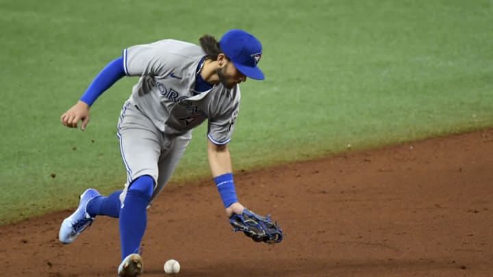 ST PETERSBURG, FLORIDA - JULY 24: Bo Bichette #11 of the Toronto Blue Jays makes an error on a ground ball from Manuel Margot #13 of the Tampa Bay Rays (not pictured) during the eighth inning on Opening Day at Tropicana Field on July 24, 2020 in St Petersburg, Florida. The 2020 season had been postponed since March due to the COVID-19 pandemic. (Photo by Douglas P. DeFelice/Getty Images)