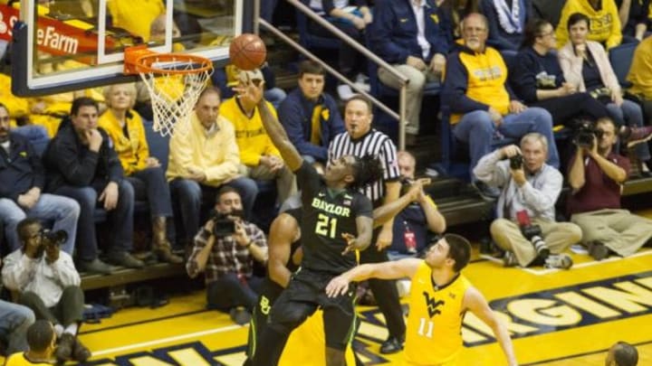 Feb 6, 2016; Morgantown, WV, USA; Baylor Bears forward Taurean Prince (21) shoots over West Virginia Mountaineers forward Nathan Adrian (11) during the first half at the WVU Coliseum. Mandatory Credit: Ben Queen-USA TODAY Sports