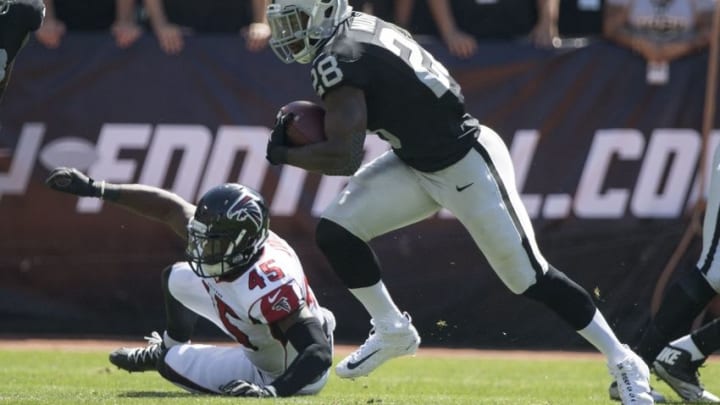 September 18, 2016; Oakland, CA, USA; Oakland Raiders running back Latavius Murray (28) runs past Atlanta Falcons outside linebacker Deion Jones (45) during the first quarter at Oakland Coliseum. Mandatory Credit: Kyle Terada-USA TODAY Sports