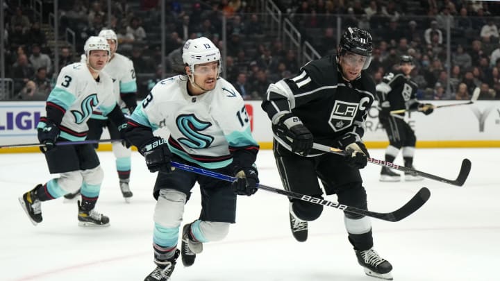 Nov. 29, 2022; Los Angeles, California, USA; LA Kings center Anze Kopitar (11) and Seattle Kraken left wing Brandon Tanev (13) battle for the puck in the second period at Crypto.com Arena. Mandatory Credit: Kirby Lee-USA TODAY Sports
