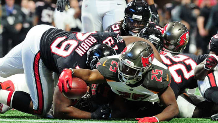 ATLANTA, GA – NOVEMBER 26: Peyton Barber #25 of the Tampa Bay Buccaneers jumps over the pile to score a touchdown during the second half against the Atlanta Falcons at Mercedes-Benz Stadium on November 26, 2017 in Atlanta, Georgia. (Photo by Scott Cunningham/Getty Images)