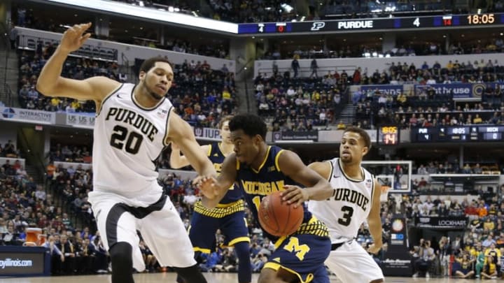 Mar 12, 2016; Indianapolis, IN, USA; Michigan Wolverines guard Derrick Walton Jr. (10) dribbles the ball as Purdue Boilermakers center A.J. Hammons (20) defends during the Big Ten Conference tournament at Bankers Life Fieldhouse. Mandatory Credit: Brian Spurlock-USA TODAY Sports