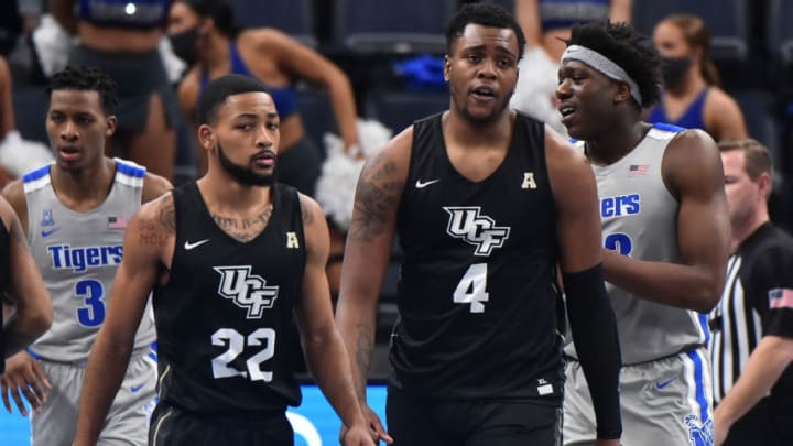 Feb 3, 2021; Memphis, Tennessee, USA; UCF Knights guard Darin Green Jr. (22) and UCF Knights forward Jamille Reynolds (4) reacts during the second half against the Memphis Tigers at FedExForum. Mandatory Credit: Justin Ford-USA TODAY Sports