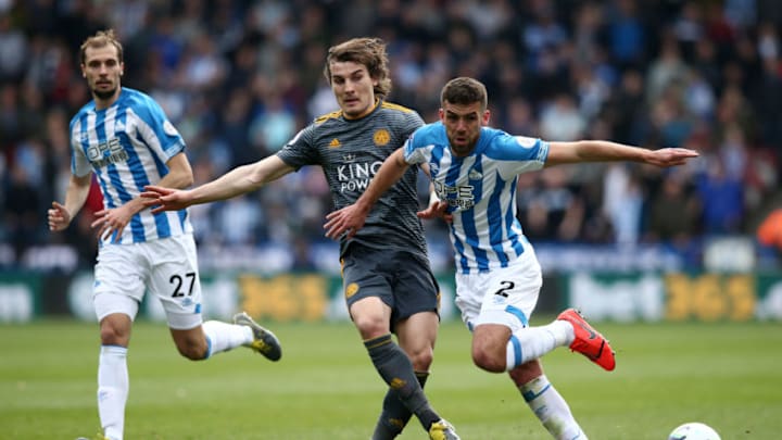 HUDDERSFIELD, ENGLAND - APRIL 06: Caglar Soyuncu of Leicester City is challenged by Tommy Smith of Huddersfield Town during the Premier League match between Huddersfield Town and Leicester City at John Smith's Stadium on April 06, 2019 in Huddersfield, United Kingdom. (Photo by Jan Kruger/Getty Images)