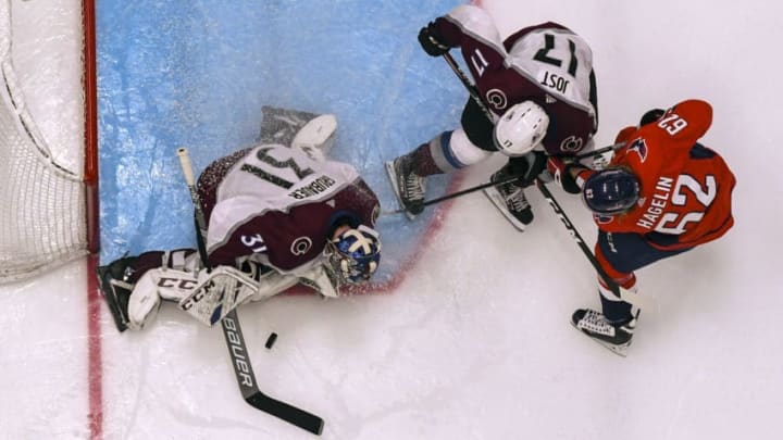 WASHINGTON, DC - OCTOBER 14: Colorado Avalanche goaltender Philipp Grubauer (31) makes a third period save on shot by Washington Capitals left wing Carl Hagelin (62) who is defended by center Tyson Jost (17) on October 14, 2019, at the Capital One Arena in Washington, D.C. (Photo by Mark Goldman/Icon Sportswire via Getty Images)