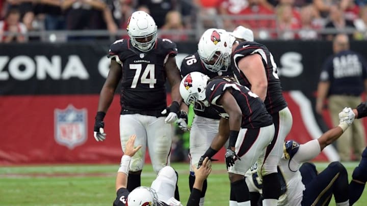 Oct 2, 2016; Glendale, AZ, USA; Arizona Cardinals quarterback Carson Palmer (3) is helped off the ground by teammates after being injured against the Los Angeles Rams during the second half at University of Phoenix Stadium. The Rams won 17-13. Mandatory Credit: Joe Camporeale-USA TODAY Sports