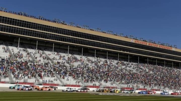 Feb 27, 2016; Hampton, GA, USA; NASCAR Xfinity Series driver Kyle Busch (18) and Erik Jones (20) lead a pack of cars during the Head Up Georgia 250 at Atlanta Motor Speedway. Mandatory Credit: John David Mercer-USA TODAY Sports
