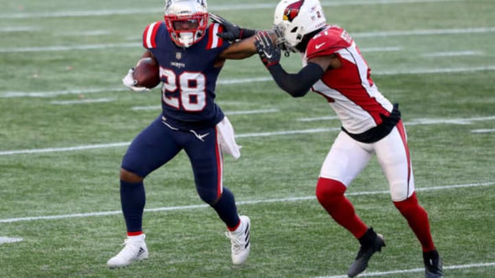 FOXBOROUGH, MASSACHUSETTS – NOVEMBER 29: James White #28 of the New England Patriots stiff arms Patrick Peterson #21 of the Arizona Cardinals during the third quarter of the game at Gillette Stadium on November 29, 2020 in Foxborough, Massachusetts. (Photo by Maddie Meyer/Getty Images)