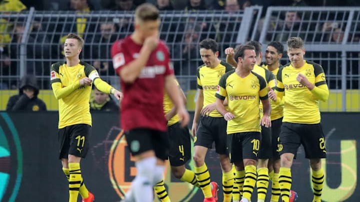 DORTMUND, GERMANY - JANUARY 26: Achraf Hakimi of Borussia Dortmund (2R) celebrates with teammates after scoring his team's first goal during the Bundesliga match between Borussia Dortmund and Hannover 96 at Signal Iduna Park on January 26, 2019 in Dortmund, Germany. (Photo by Christof Koepsel/Bongarts/Getty Images)