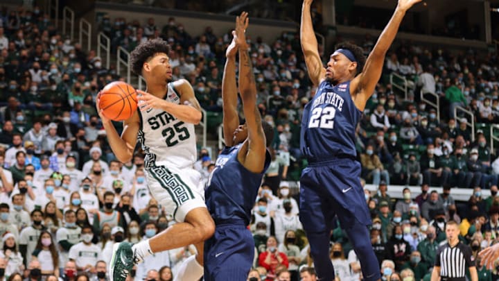Malik Hall #25 of the Michigan State Spartans looks to pass the ball against Jalen Pickett #22 and Sam Sessoms #3 of the Penn State Nittany Lions (Photo by Rey Del Rio/Getty Images)