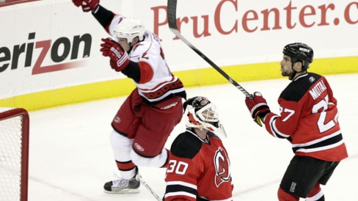 The Carolina Hurricanes' Eric Staal (12) celebrates after he scored against the New Jersey Devils' Martin Brodeur (30) and Mike Mottau (27) during third period action in Game 7 of the NHL playoffs at the Prudential Center in Newark, New Jersey, Tuesday, April 28, 2009. The Hurricanes beat the Devils 4-3 to win the best-of-seven series, four games to three. (Photo by Chris Seward/Raleigh News & Observer/Tribune News Service via Getty Images)