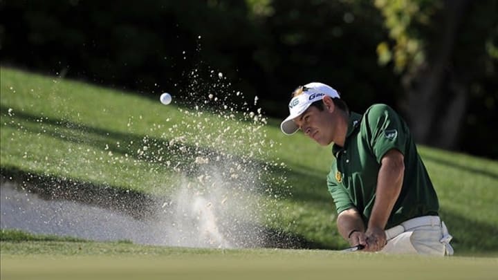 Apr 8, 2012; Augusta, GA, USA; Louis Oosthuizen hits out of a bunker on the 10th hole during the final round of the 2012 The Masters golf tournament at Augusta National Golf Club. Mandatory Credit: Michael Madrid-USA TODAY Sports