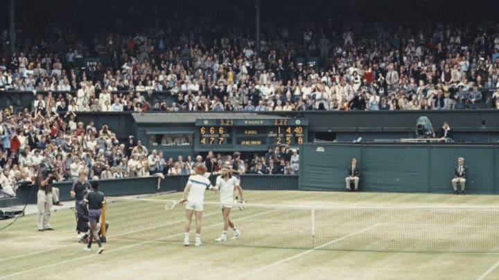 John McEnroe of the United States reaches over the net to shake hands with Bjorn Borg after defeating him during the Men's Singles Final match at the Wimbledon Lawn Tennis Championship on 4 July 1981 at the All England Lawn Tennis and Croquet Club in Wimbledon in London, England. (Photo by Tony Duffy/Allsport/Getty Images)