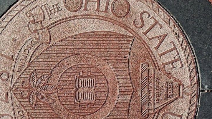 Ohio State University regularly uses the definitive article "The" in front of its name, as seen here in the university seal embedded in the pavement at the east entrance to the Oval on the main campus in Columbus.The Ohio State University