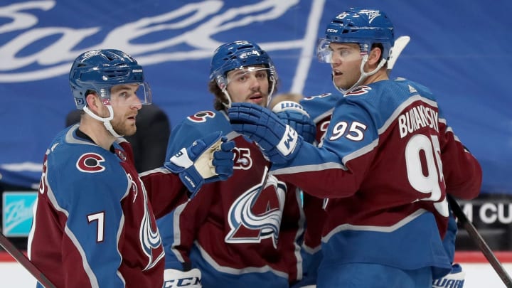DENVER, COLORADO – MARCH 16: Andre Burakovsky #95 of the Colorado Avalanche celebrates with Devon Toews #7 and Samuel Girard #49 after scoring against the Anaheim Ducks in the second period at Ball Arena on March 16, 2021 in Denver, Colorado. (Photo by Matthew Stockman/Getty Images)