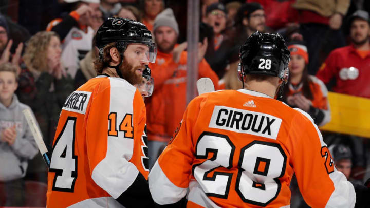 PHILADELPHIA, PA - JANUARY 06: Sean Couturier #14 of the Philadelphia Flyers is congratulated by teammate Claude Giroux #28 after Couturier scored in the second period against the St. Louis Blues on January 6, 2018 at Wells Fargo Center in Philadelphia, Pennsylvania. (Photo by Elsa/Getty Images)