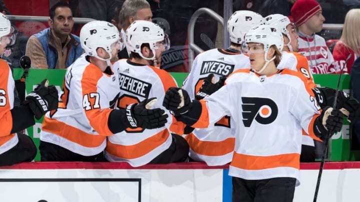 DETROIT, MI - FEBRUARY 17: Oskar Lindblom #23 of the Philadelphia Flyers pounds gloves with teammates on the bench following his first period goal during an NHL game against the Detroit Red Wings at Little Caesars Arena on February 17, 2019 in Detroit, Michigan. (Photo by Dave Reginek/NHLI via Getty Images)