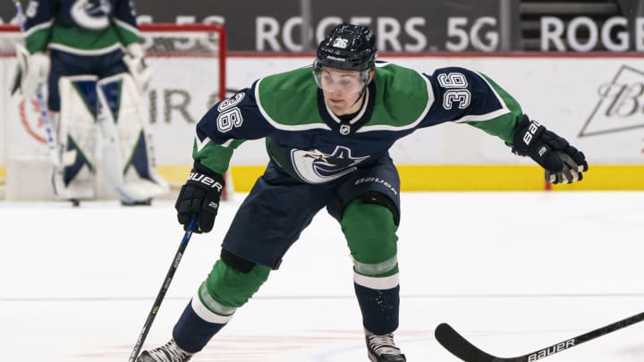 VANCOUVER, BC – FEBRUARY 19: Nils Hoglander #36 of the Vancouver Canucks skates with the puck during NHL hockey action. (Photo by Rich Lam/Getty Images)