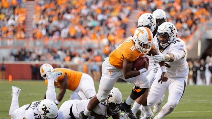 KNOXVILLE, TN - NOVEMBER 17: Ty Chandler #8 of the Tennessee Volunteers runs for yards and avoids a tackle from Joe Hoy #53 of the Missouri Tigers during the first half of the game between the Missouri Tigers and the Tennessee Volunteers at Neyland Stadium on November 17, 2018 in Knoxville, Tennessee. (Photo by Donald Page/Getty Images)