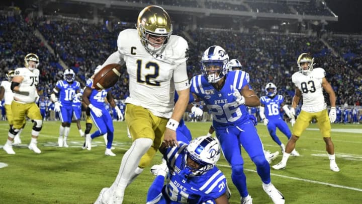 DURHAM, NORTH CAROLINA - NOVEMBER 09: Josh Blackwell #31 and Michael Carter II #26 of the Duke Blue Devils chase Ian Book #12 of the Notre Dame Fighting Irish out of bounds during the first quarter of their game at Wallace Wade Stadium on November 09, 2019 in Durham, North Carolina. (Photo by Grant Halverson/Getty Images)